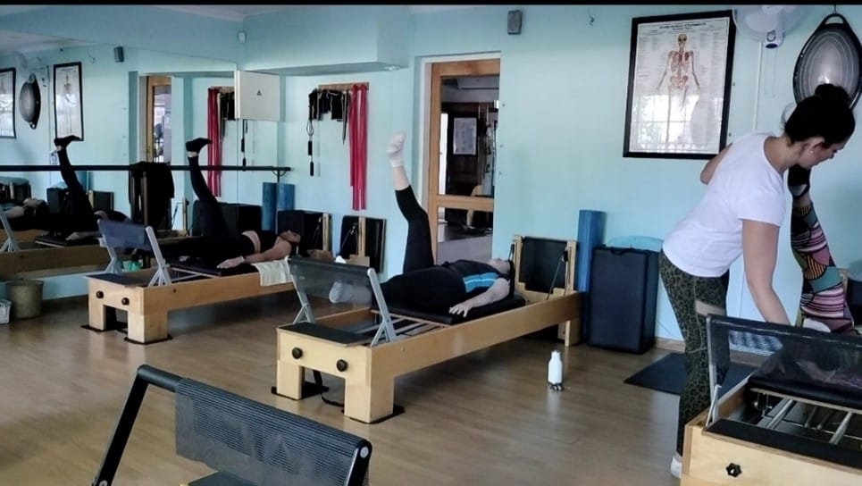 Small group Pilates class in progress on the Reformers