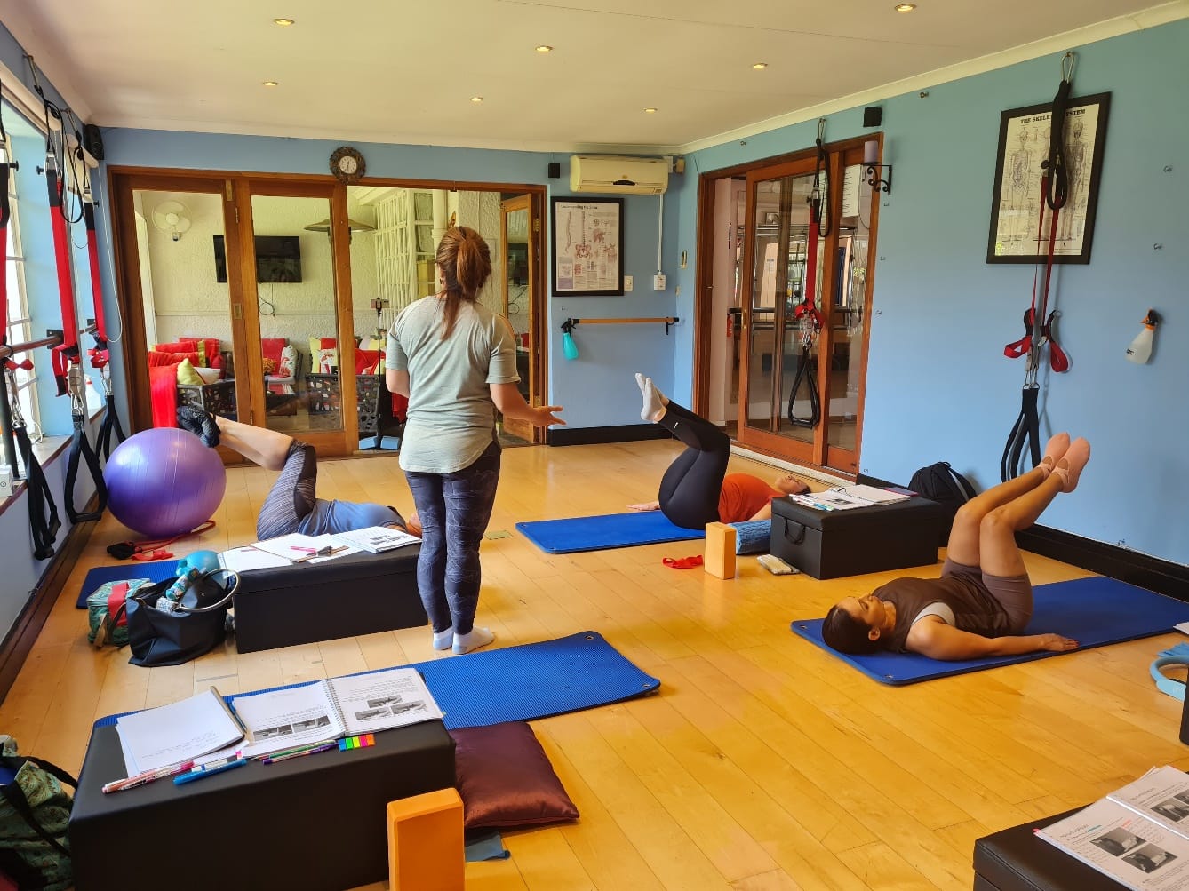 Pilates instructor teaching a small group class