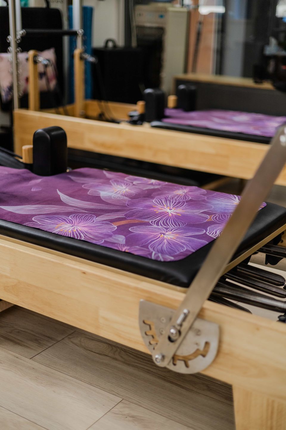 Wooden Pilates reformers with floral mats in the Pilates Dynamics studio, Randburg