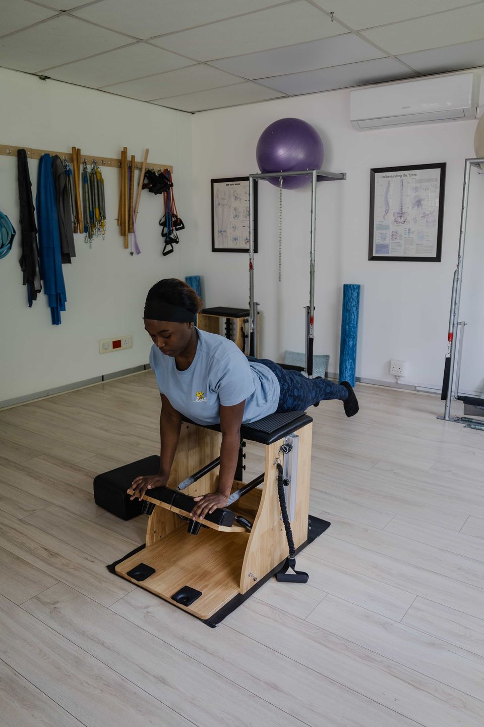 A prone back-extension exercise on the Wunda chair in a large-equipment Pilates class in Randburg