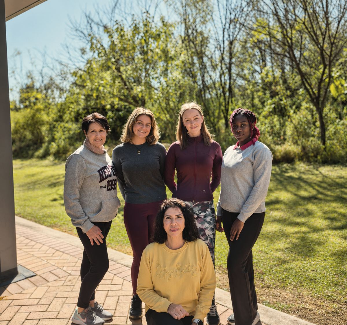 The Pilates Dynamics team in the garden beside the studio